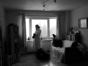 The tone in this photo is partially due to the woman's pose. It's also due to the lighting and coloring. The effect would be different if the photograph were in color.